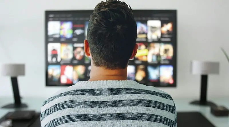 A person standing in front of a screen